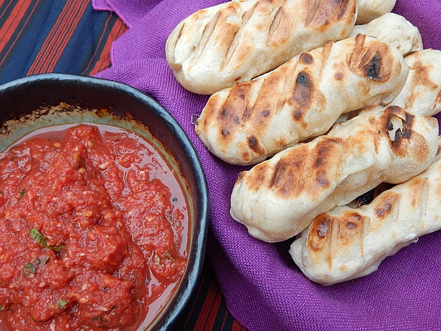 Grilling a small batch of tomatoes to sauce and freeze in cubes creates an ideal dip for mozzarella-filled breadsticks. Learn to make Grilled Tomato Pizza Sauce and Stuffed and Grilled Breadsticks.
